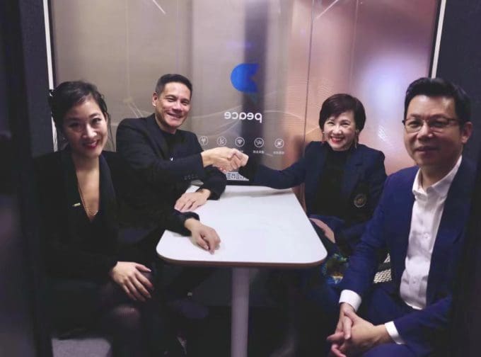 four people sitting at a table in a room